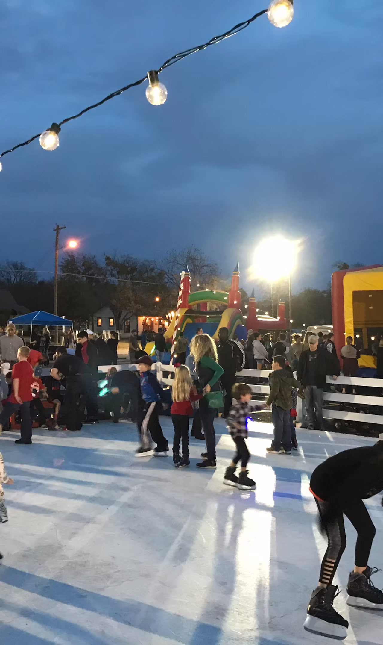 A crowd gathered around a Classic Holiday rink